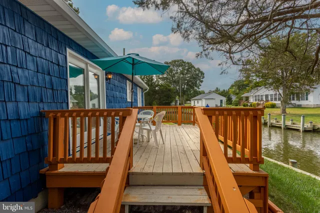 a balcony with wooden floor and outdoor seating
