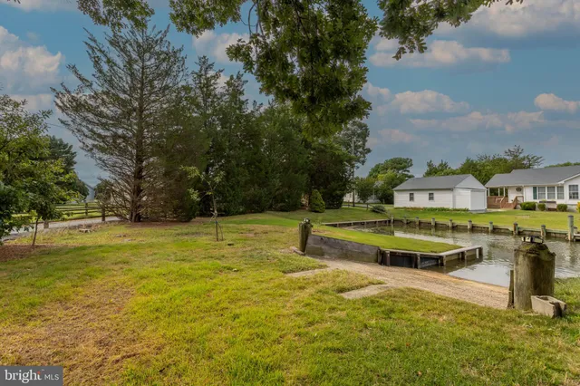 a swimming pool with outdoor seating and yard