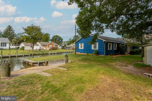 a view of a house with pool and a yard