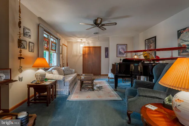 a living room with furniture a rug and a flat screen tv