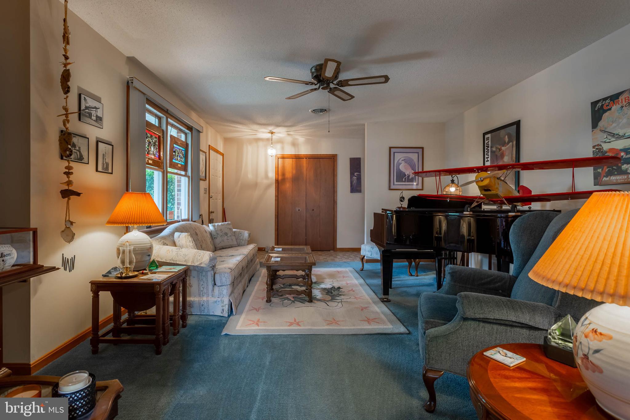 32396 Holly Ter Road Ocean View, DE 19970 - Photo 5 of 42 a living room with furniture a rug and a flat screen tv