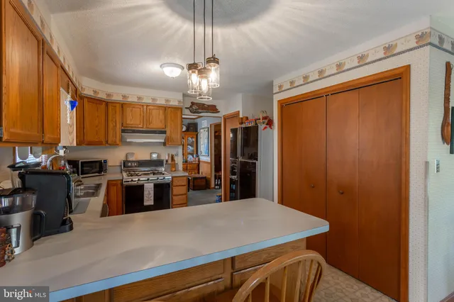 a kitchen with stainless steel appliances a refrigerator and a stove top oven
