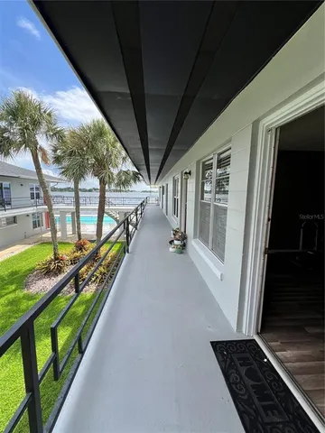 a view of a house with backyard and porch