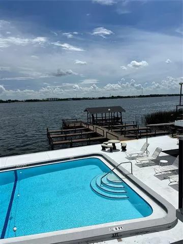 a view of a swimming pool with furniture
