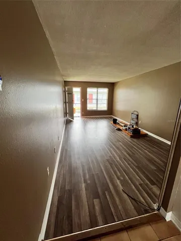a view of a room with wooden floor and window