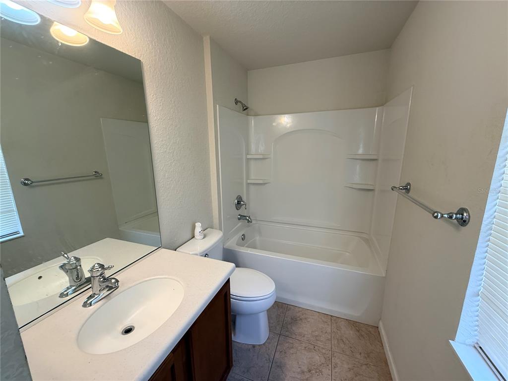 4199 Southwest 46th Court Ocala, FL 34474 - Photo 40 of 50 a bathroom with a sink a toilet and shower