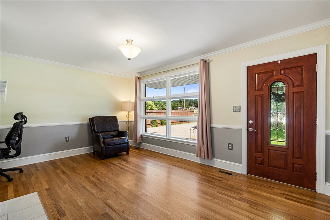 512 East Fredericks Street Anderson, SC 29621 - Photo 5 of 31 Natural wood floors and a broad window illuminate this inviting entry space.
