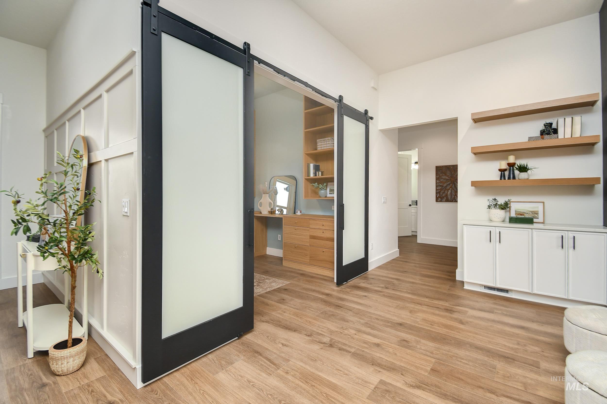 8991 Edna Lane Middleton, ID 83644 - Photo 11 of 50 Corridor featuring a barn door and light wood-style flooring