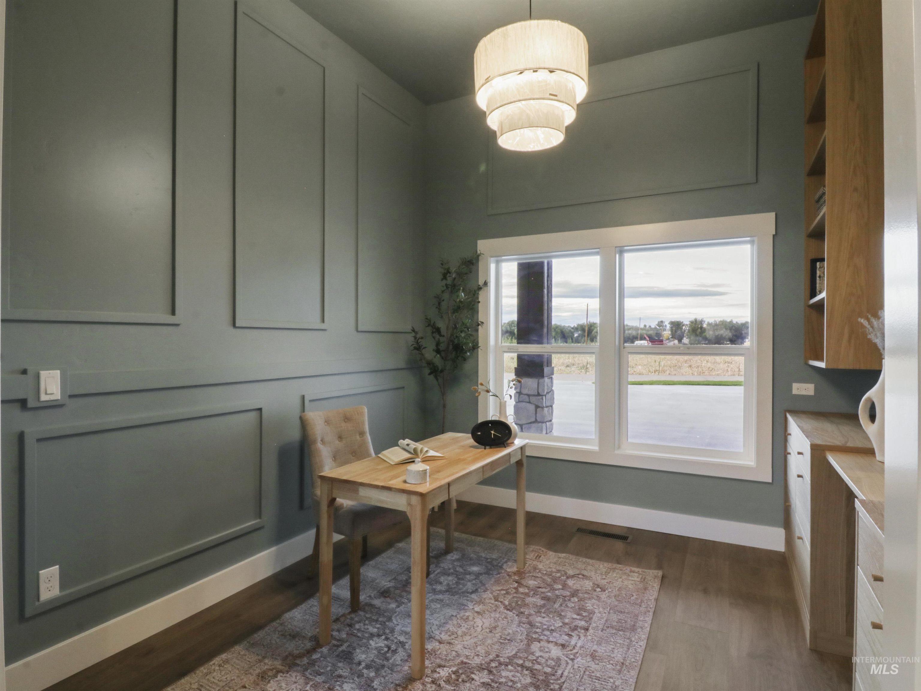 8991 Edna Lane Middleton, ID 83644 - Photo 14 of 50 Home office with dark wood-style floors and a decorative wall