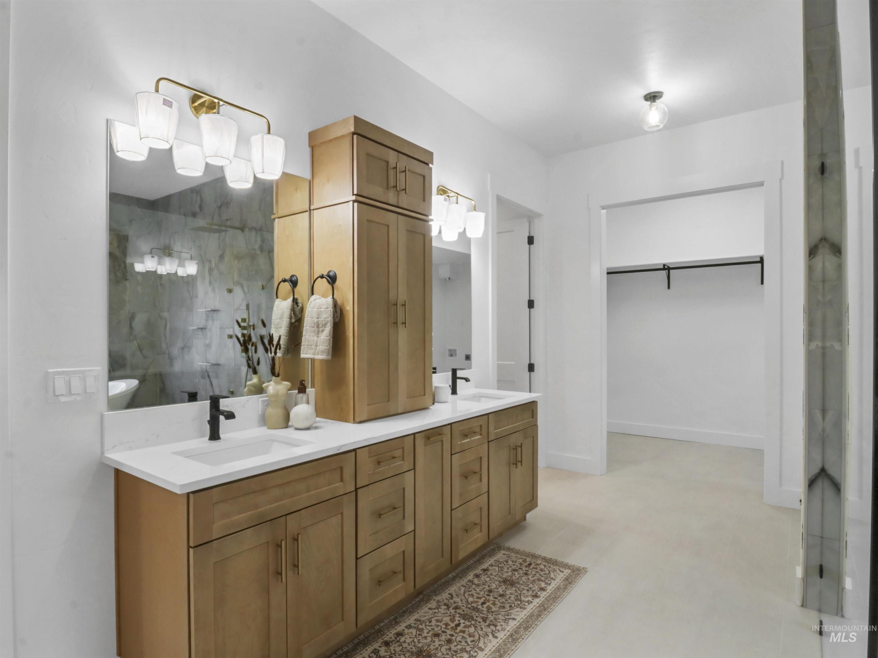 8991 Edna Lane Middleton, ID 83644 - Photo 17 of 50 Bathroom with double vanity, a spacious closet, and a shower with door