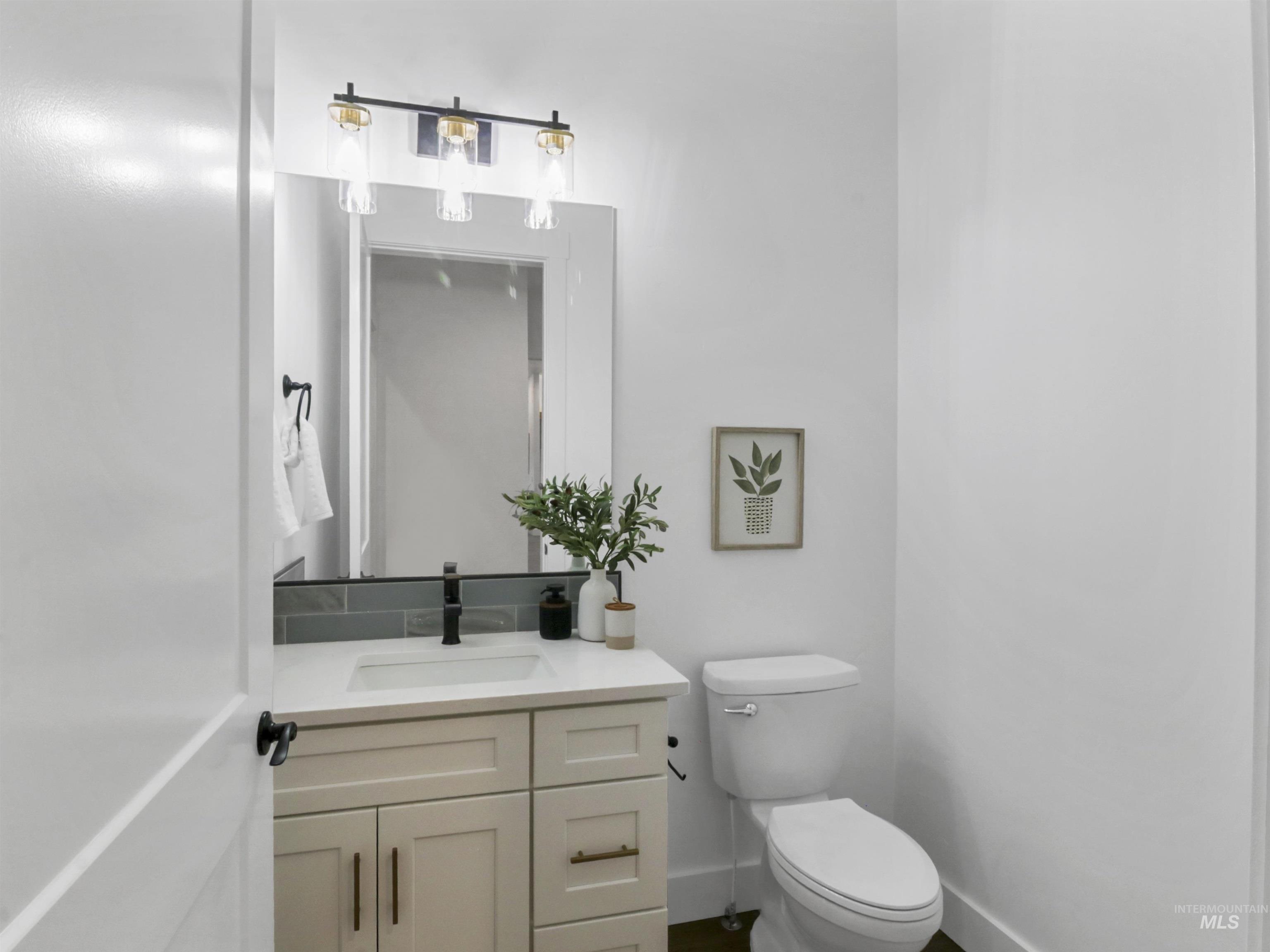 8991 Edna Lane Middleton, ID 83644 - Photo 35 of 50 Half bathroom with vanity and toilet