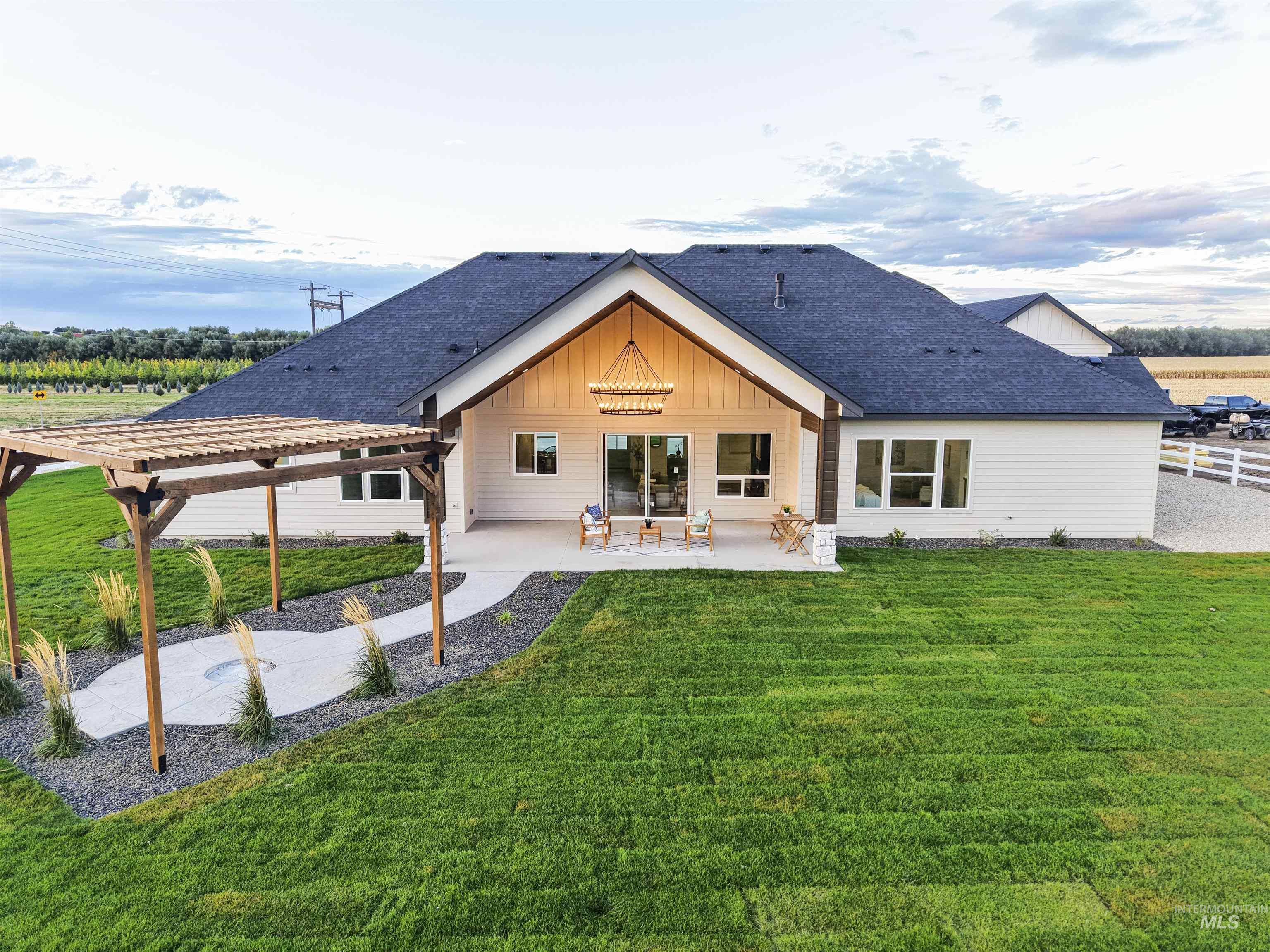 8991 Edna Lane Middleton, ID 83644 - Photo 42 of 50 Back of house featuring a patio area, a lawn, and roof with shingles
