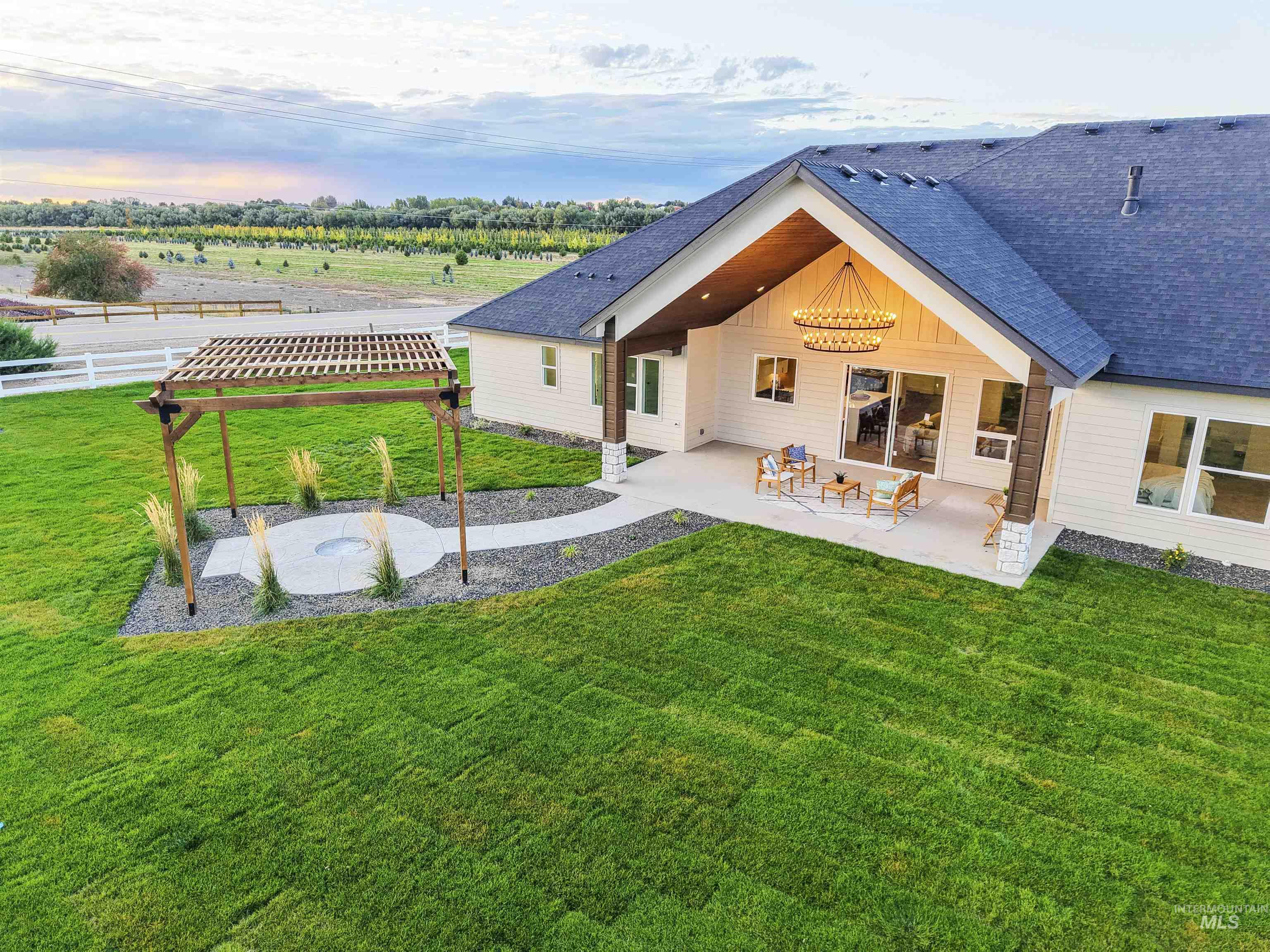 8991 Edna Lane Middleton, ID 83644 - Photo 43 of 50 Back of house with a patio and roof with shingles