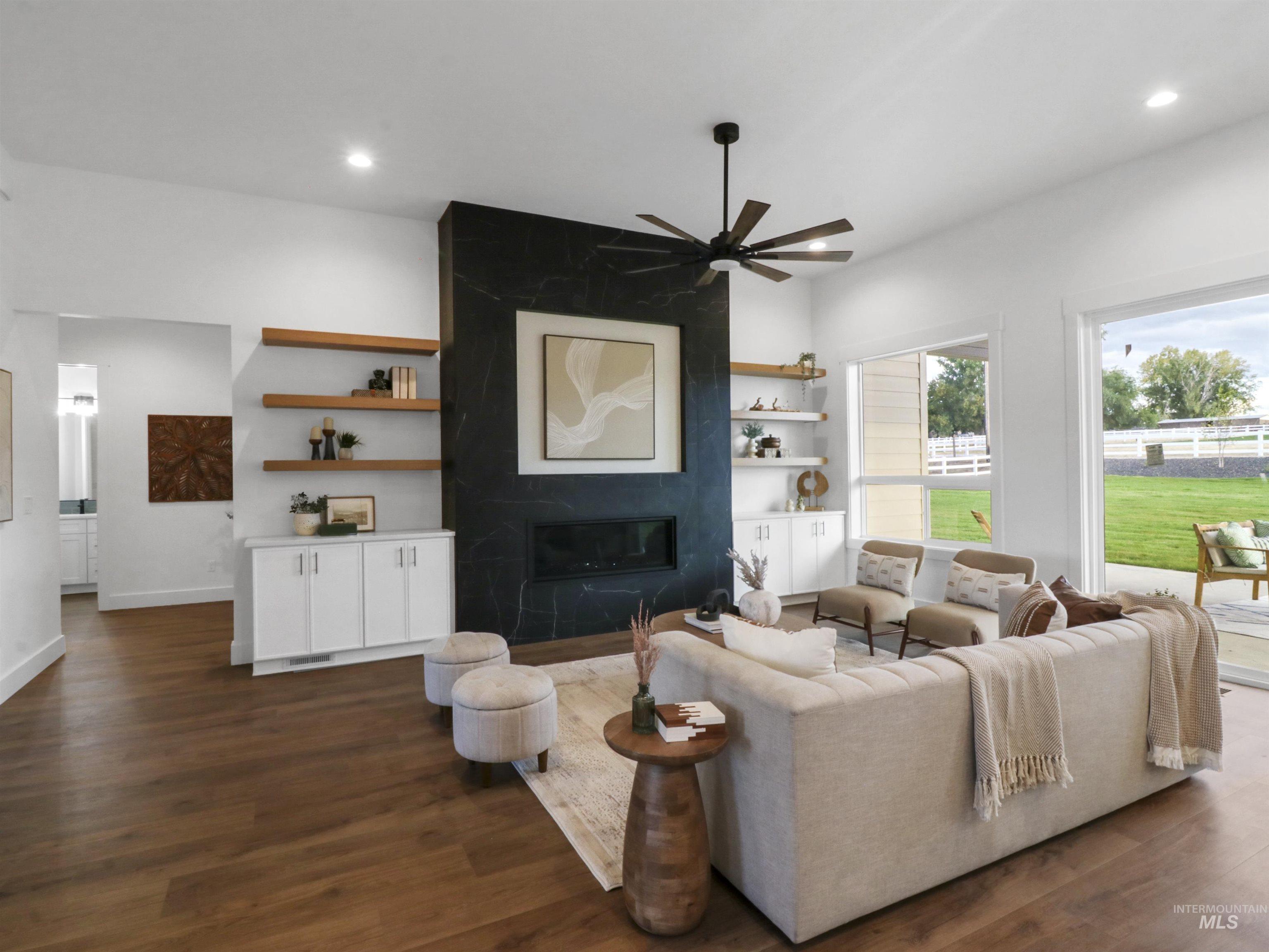 8991 Edna Lane Middleton, ID 83644 - Photo 5 of 50 Living area featuring a premium fireplace, dark wood-style floors, ceiling fan, and recessed lighting