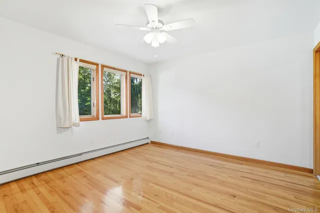 wooden floor in an empty room with a window