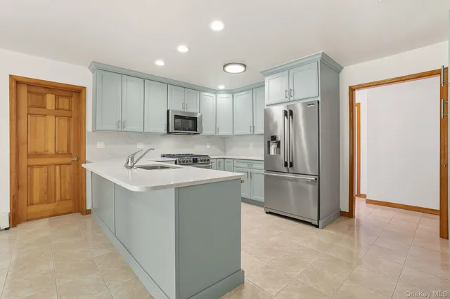 a kitchen with a refrigerator sink and microwave