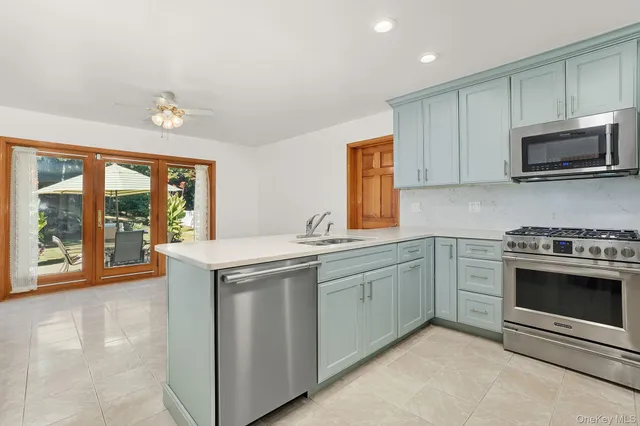 a kitchen with stainless steel appliances granite countertop a stove and a microwave