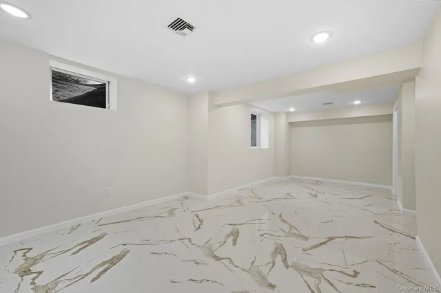 a bathroom with a granite countertop sink a mirror and shower