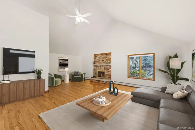 a view of a yard with plants and large trees