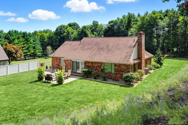 a view of a house with a yard porch and sitting area