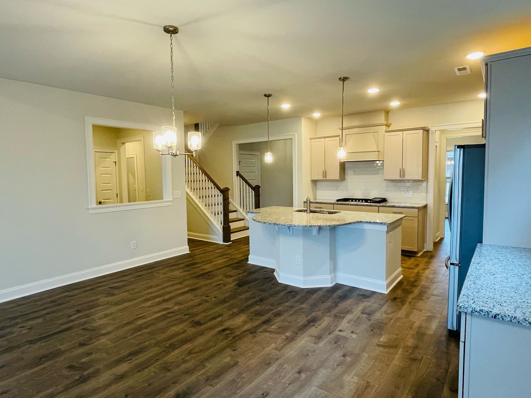 1108 Carlisle Place Mount Juliet, TN 37122 - Photo 3 of 20 a kitchen with kitchen island a stove a refrigerator wooden floor and a sink
