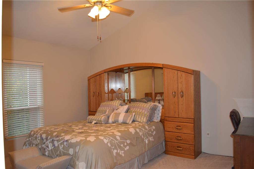 Master Bedroom with lighted ceiling fan. 