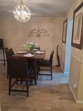 a view of a dining room with furniture and chandelier