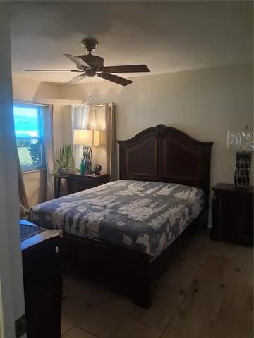 a bedroom with a bed table and window