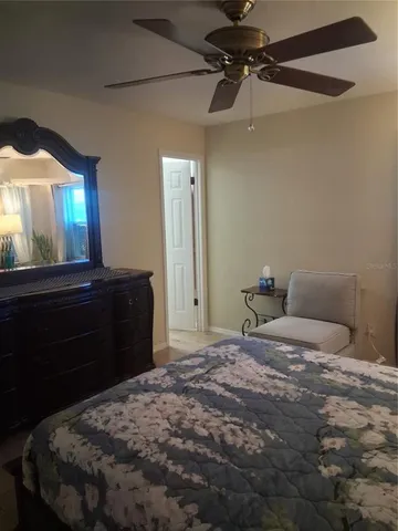 a bedroom with a bed and a mirror