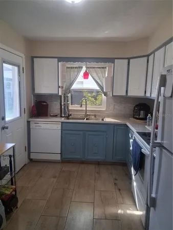 a kitchen with a sink cabinets and window