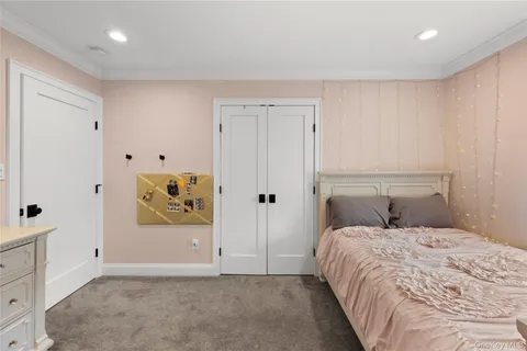 a bedroom with a bed and painting on the wall
