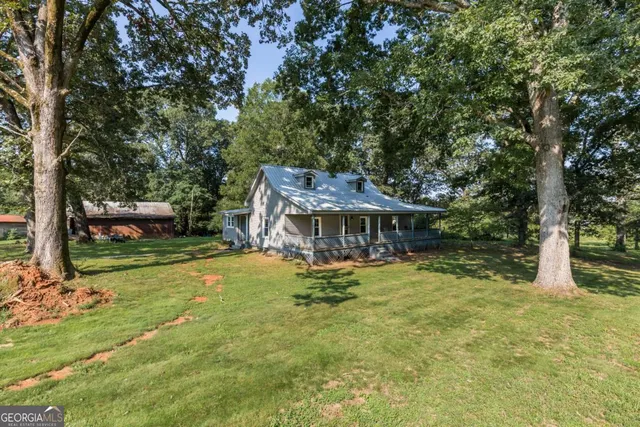 a view of a house with a yard garage and furniture