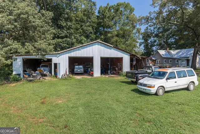 a front view of a house with a garden and trees