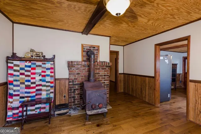 a kitchen with stainless steel appliances granite countertop a stove a sink dishwasher a dining table and chairs with wooden floor