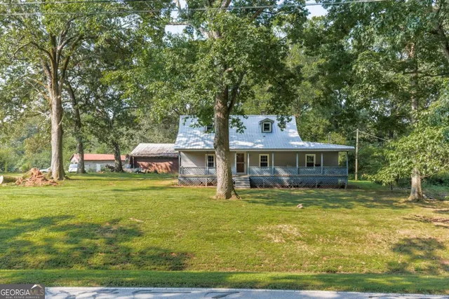 a backyard of a house with yard table and chairs