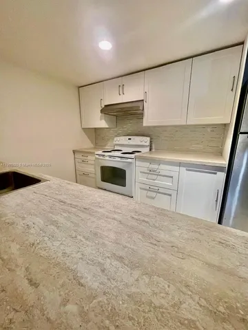 a kitchen with a stove and a sink