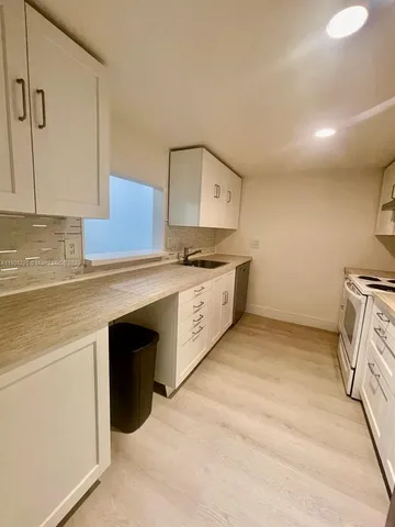 a kitchen with stainless steel appliances granite countertop a stove and a sink