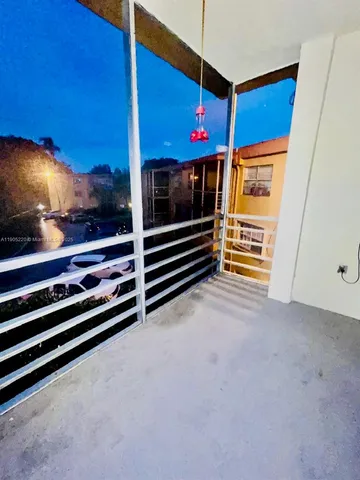 a view of an empty room with a fireplace and painted walls