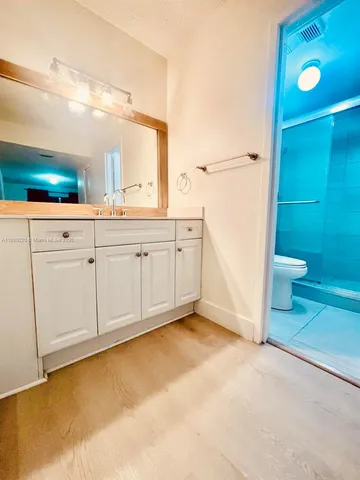 a bathroom with a sink vanity and mirror