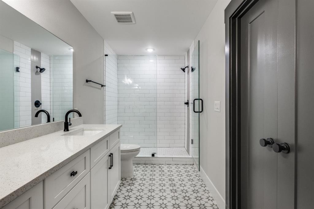 1610 Palladio Loop Princeton, TX 75407 - Photo 12 of 20 a bathroom with a double vanity sink toilet and shower