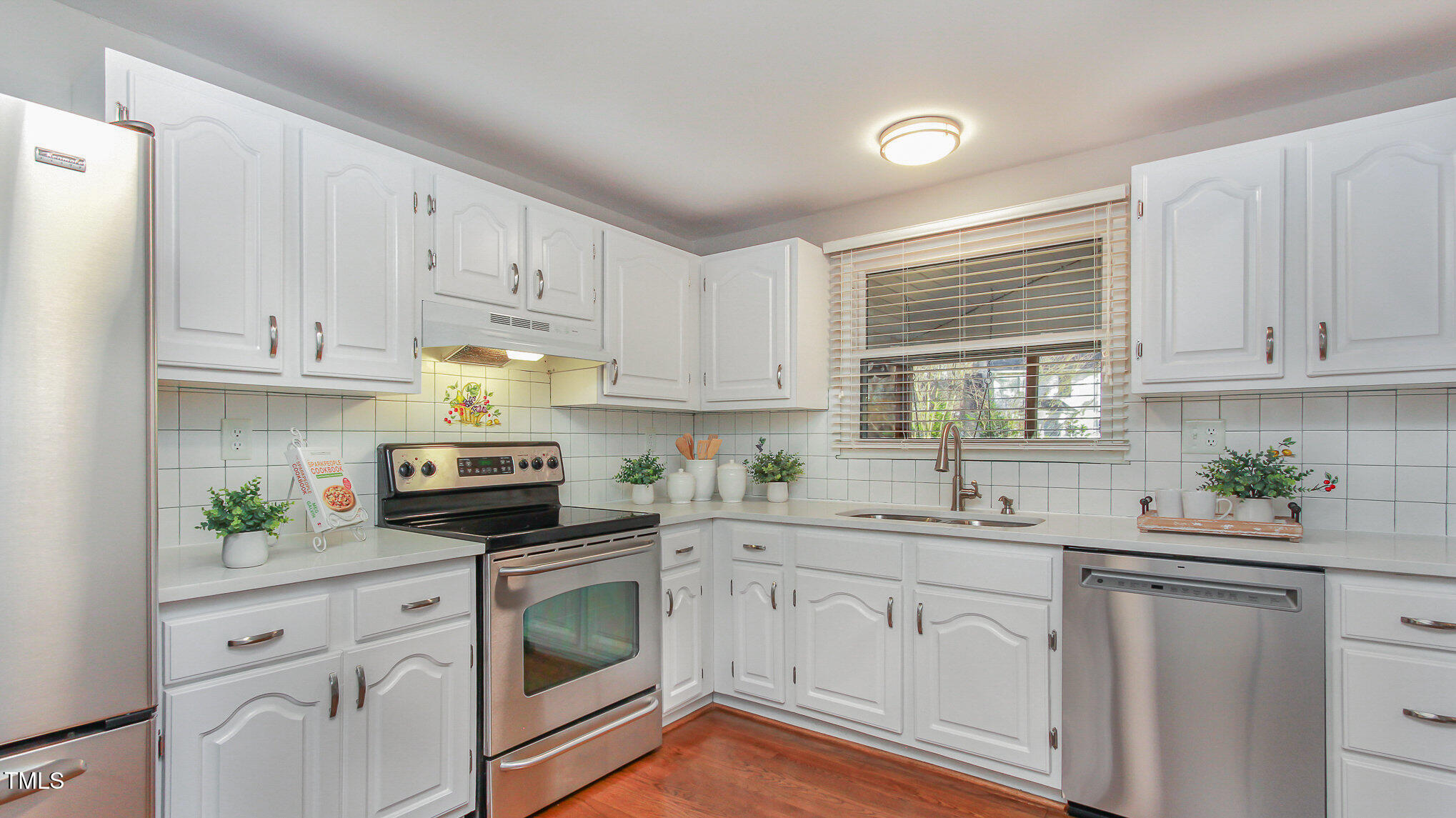 918 Templeridge Road Wake Forest, NC 27587 - Photo 3 of 12 a kitchen with white cabinets white appliances and sink