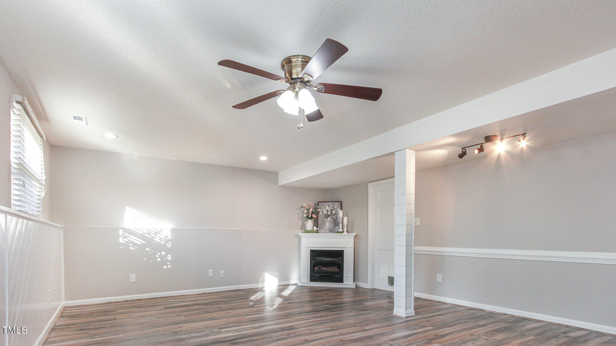 918 Templeridge Road Wake Forest, NC 27587 - Photo 8 of 12 a view of a livingroom with a fireplace a chandelier fan and wooden floor