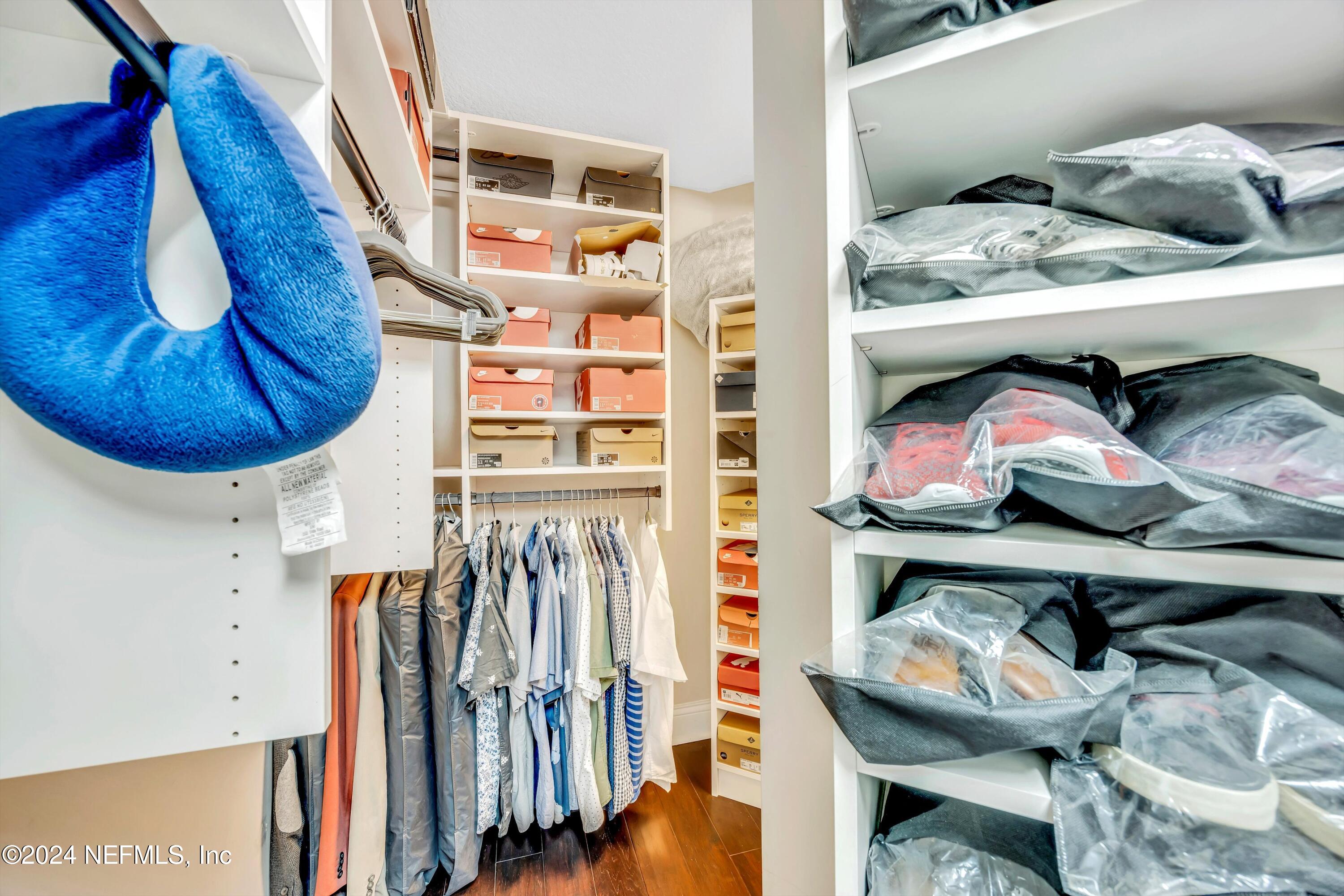 1843 South Landguard Road St. Augustine, FL 32092 - Photo 22 of 67 a view of walk in closet with clothes and shoes