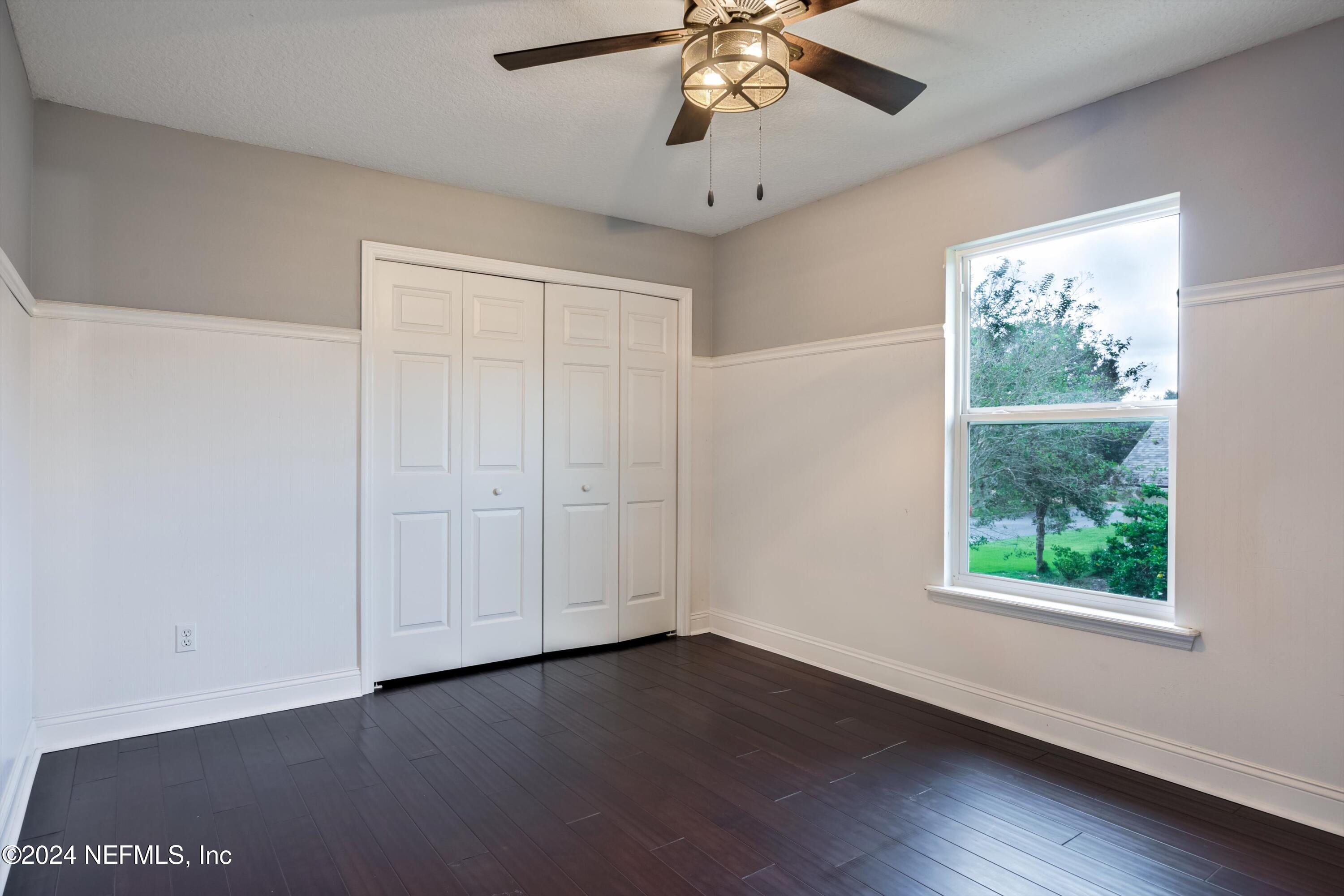 1843 South Landguard Road St. Augustine, FL 32092 - Photo 26 of 67 a view of an empty room with a window and wooden floor