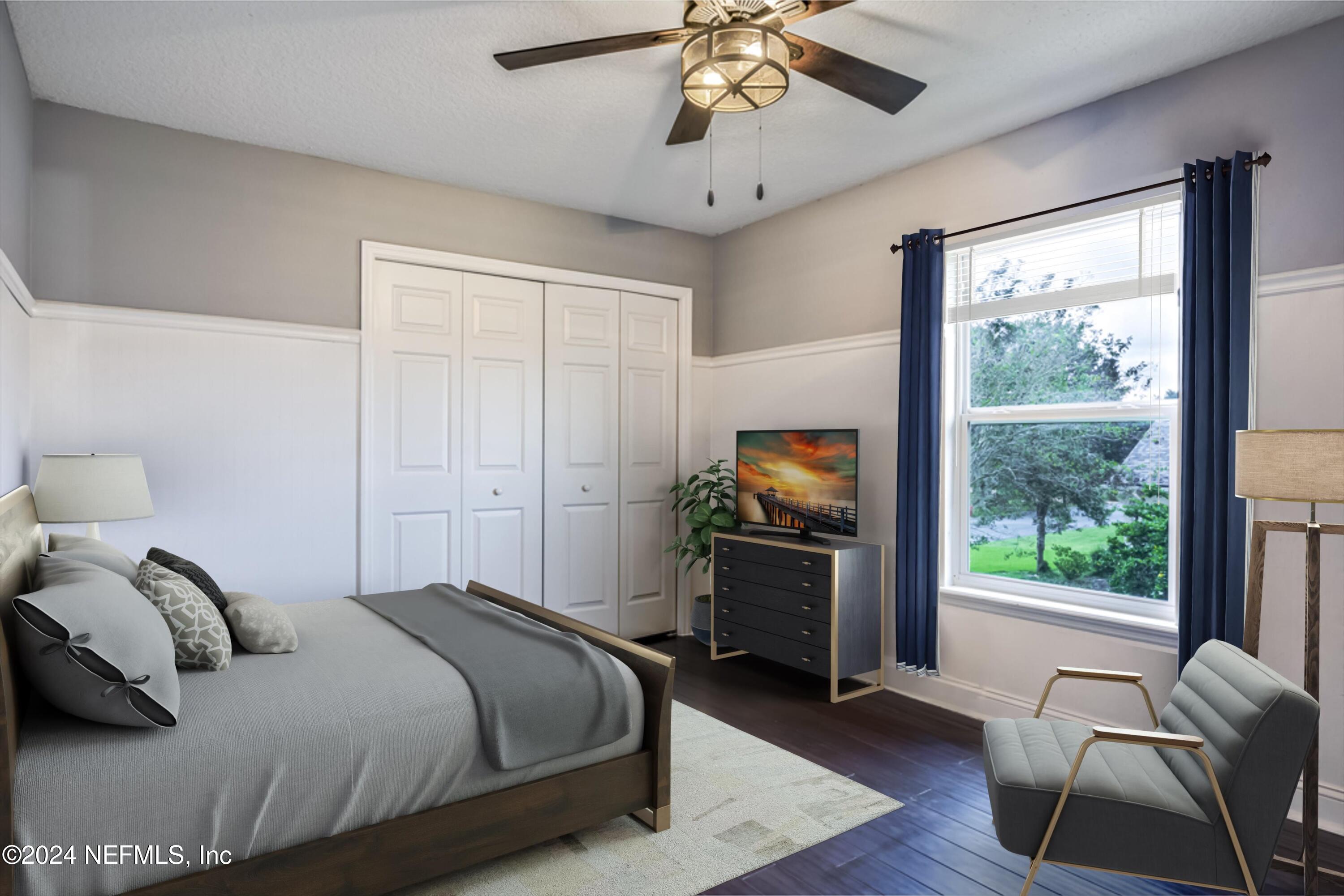 1843 South Landguard Road St. Augustine, FL 32092 - Photo 27 of 67 a bedroom with a bed and a chandelier