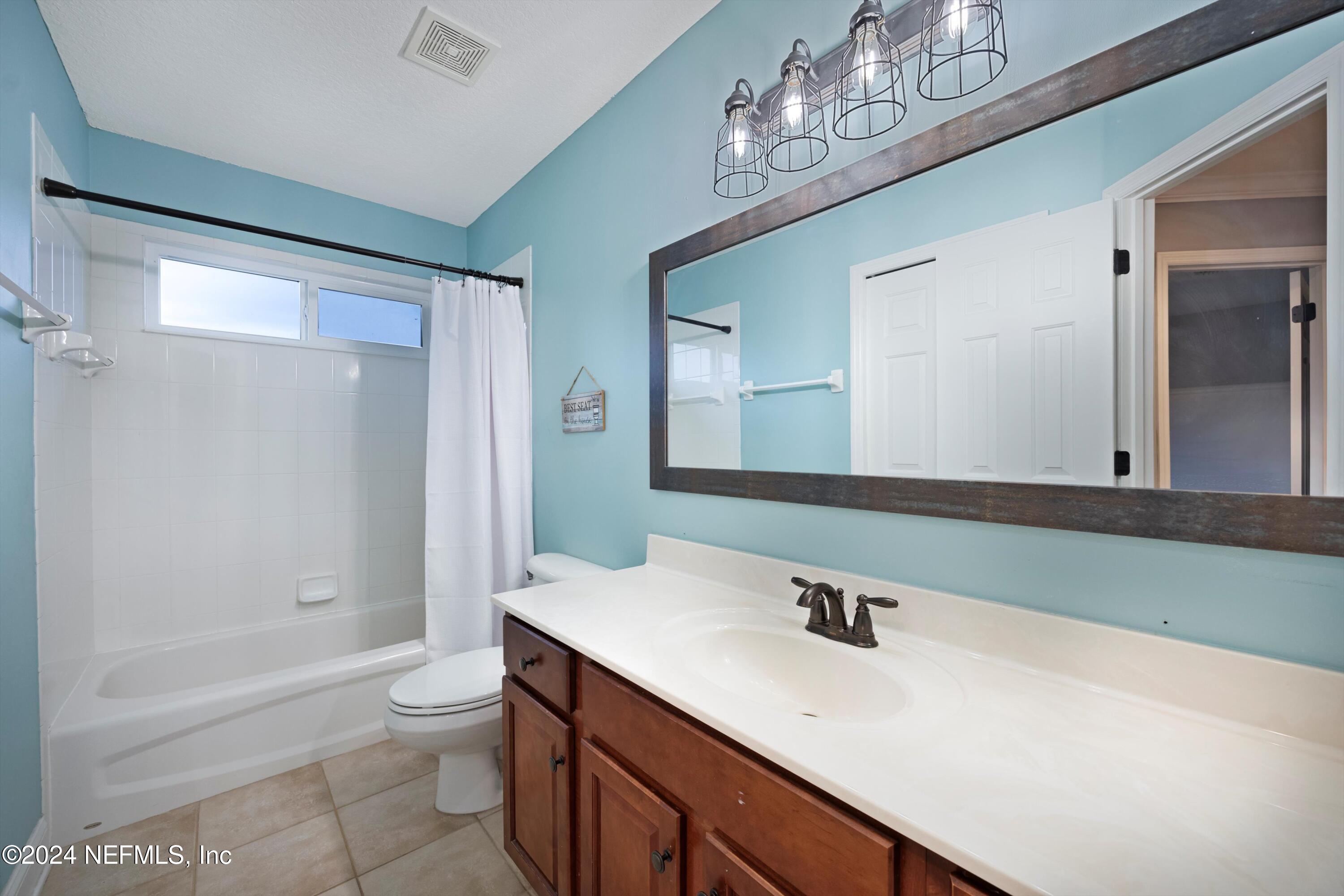 1843 South Landguard Road St. Augustine, FL 32092 - Photo 28 of 67 a bathroom with a sink a toilet and a large mirror