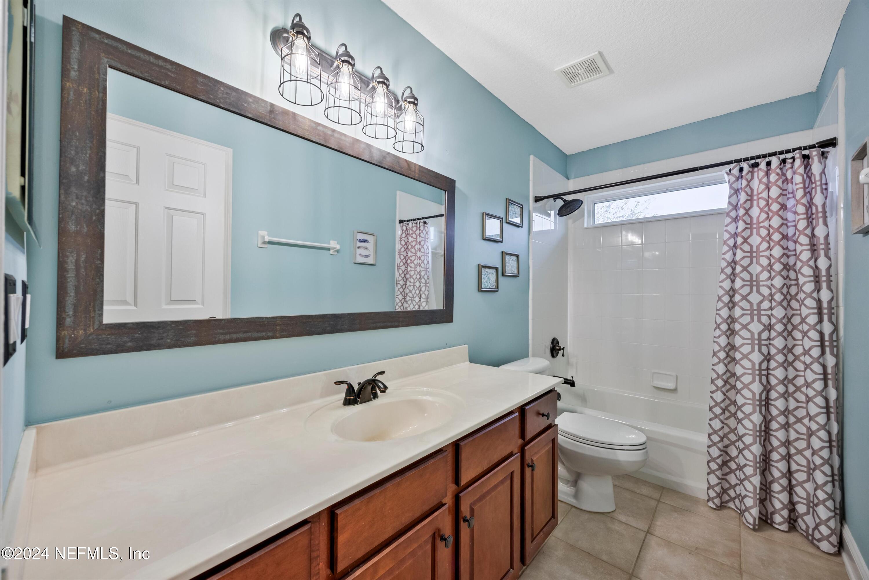 1843 South Landguard Road St. Augustine, FL 32092 - Photo 31 of 67 a bathroom with a sink toilet a shower and a mirror