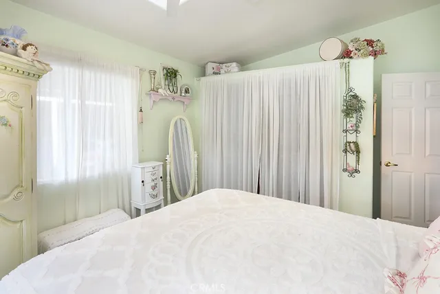 a bedroom with a bed and a window