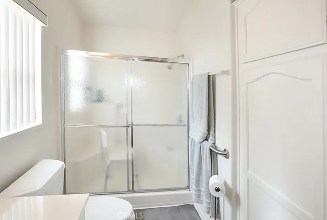 a bathroom with a shower and a toilet