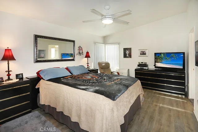 a bed room with a bed and a television